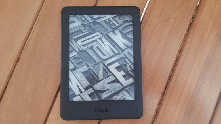 a kindle e-reader placed on wooden slats