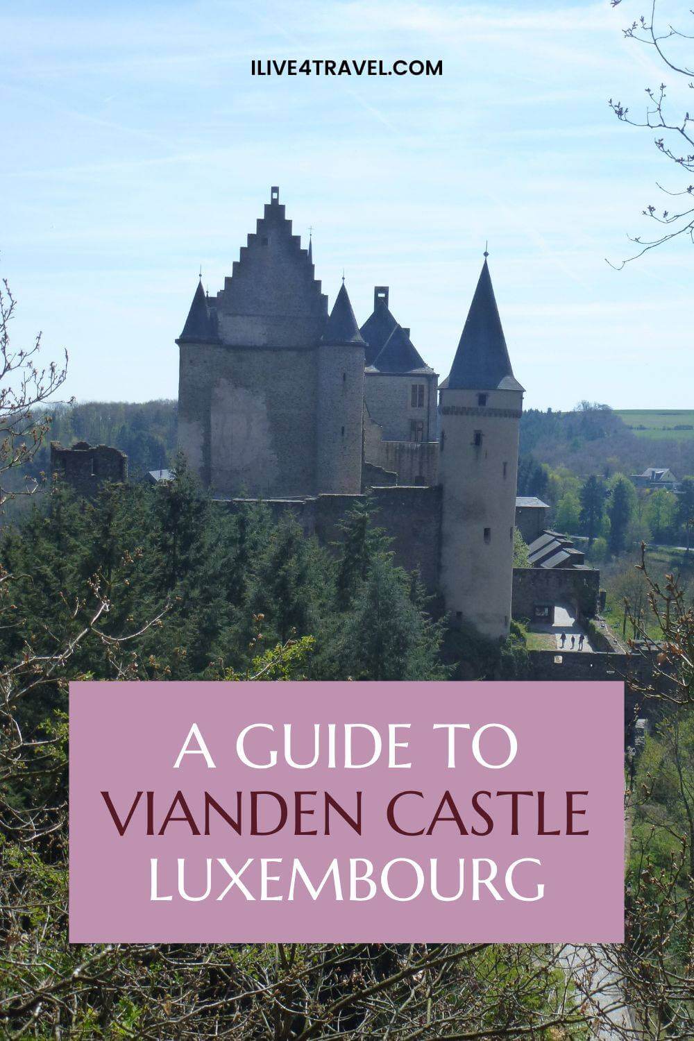 a pin created by i live for travel about A Guide to Vianden Castle Luxembourg, showing a castle on a hill from between some trees and trees all around it, the castle has many round turrets with pointed roofs