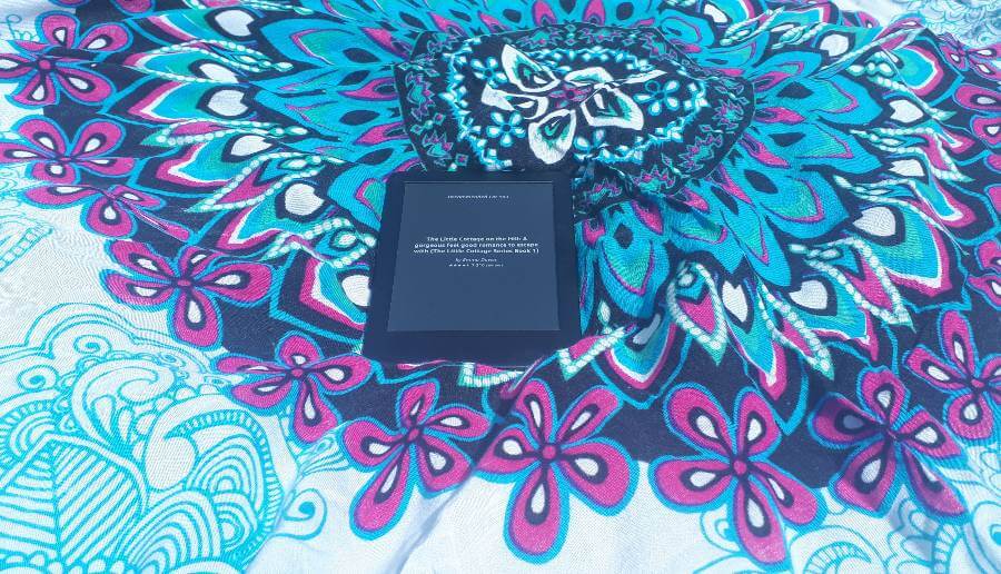 a kindle on a mandala blanket