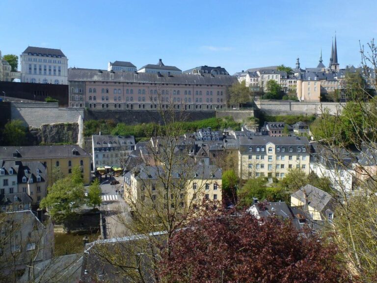buildings in a valley with buildings on the top of it as well on a clear sunny day