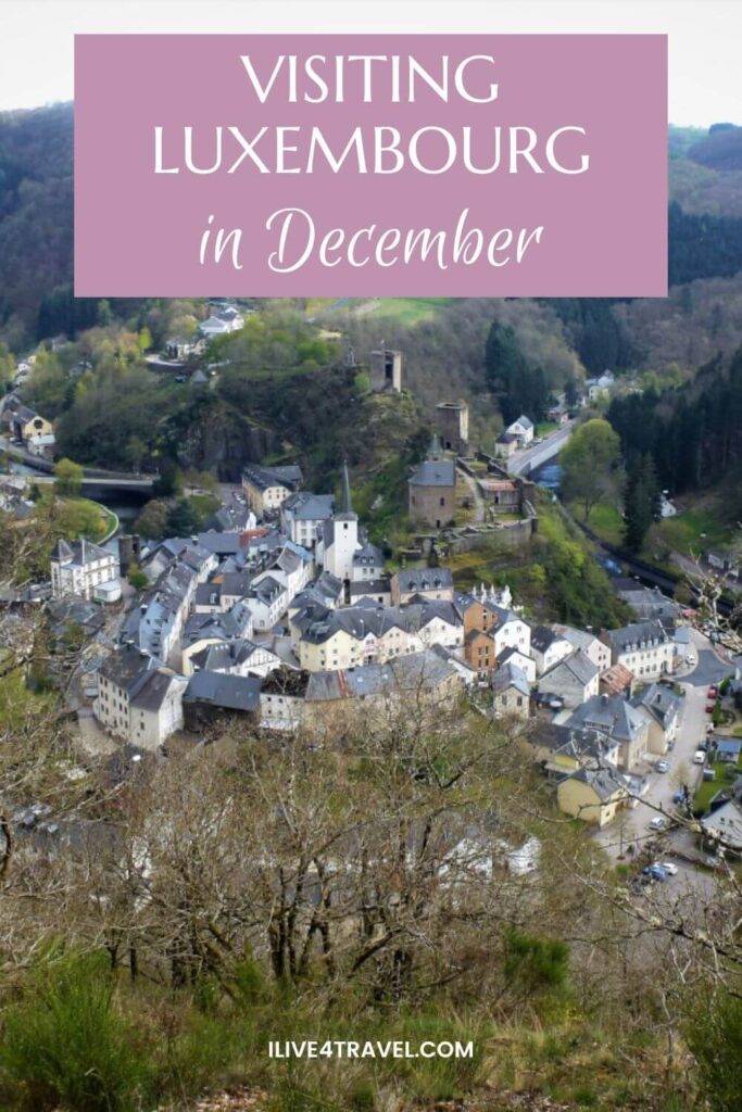 a pinterest pin about visiting luxembourg in december showing a town of white houses in a horseshoe shape with some ruins of a castle too