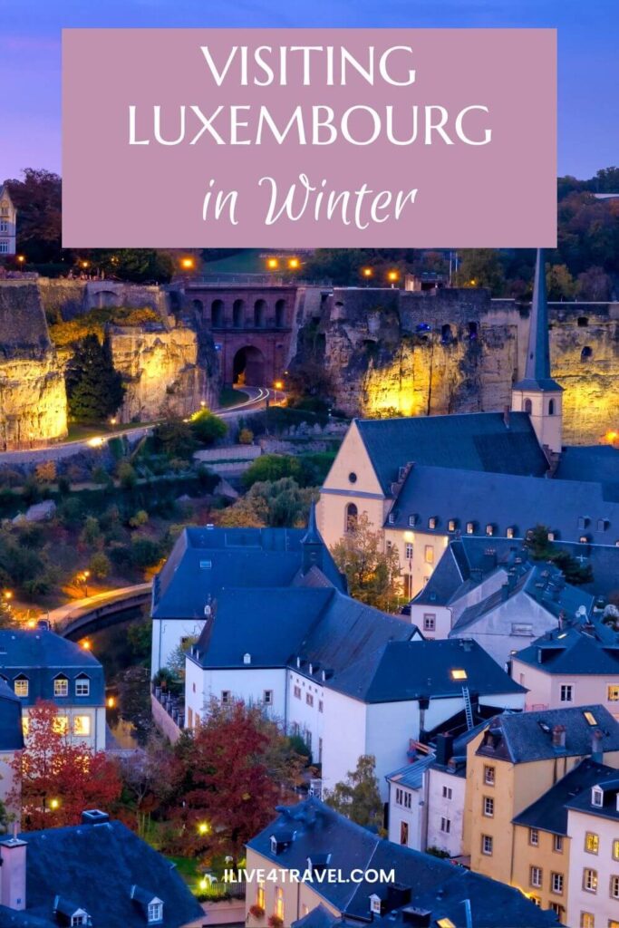 a pinterest pin created about visiting luxembourg in winter, showing the valley lit up at night with houses