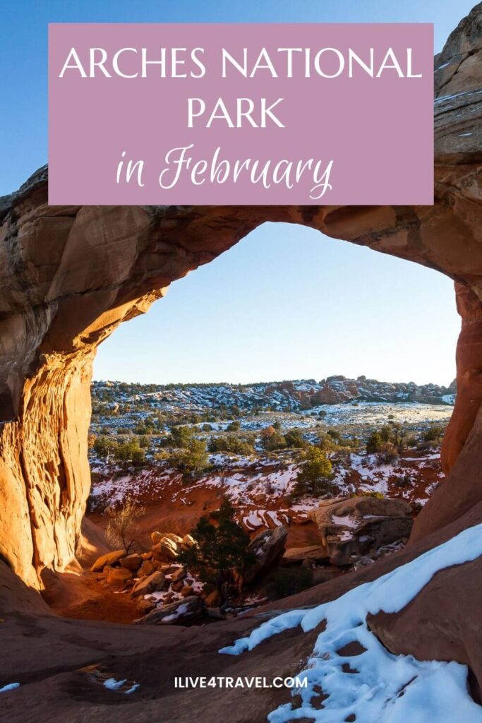 a pinterest pin about Arches National Park in February, showing an archway through a huge rock, with snow on the ground and trees on the ground in the distance