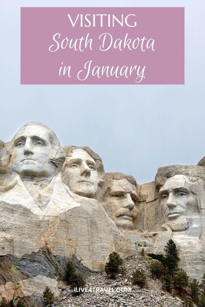 Pinterest pin featuring Mount Rushmore in South Dakota, with the carved stone faces of George Washington, Thomas Jefferson, Theodore Roosevelt, and Abraham Lincoln against a pale winter sky. A pink text overlay reads "Visiting South Dakota in January".