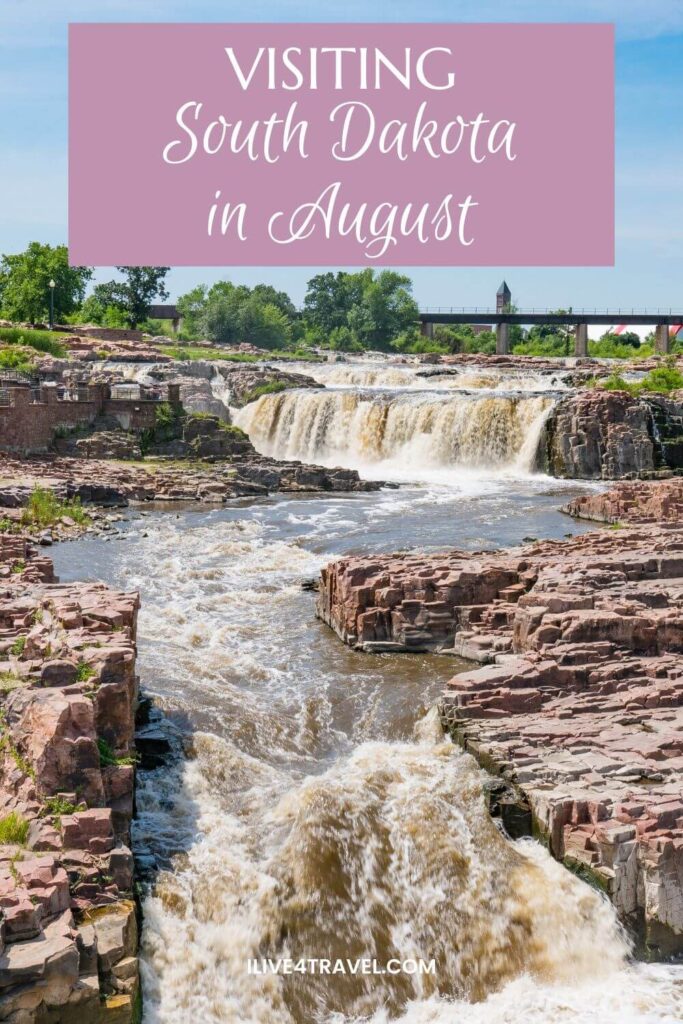 a pinterest pin about visiting south dakota in august showing an image or small waterfalls through a river with a bridge and trees in the background
