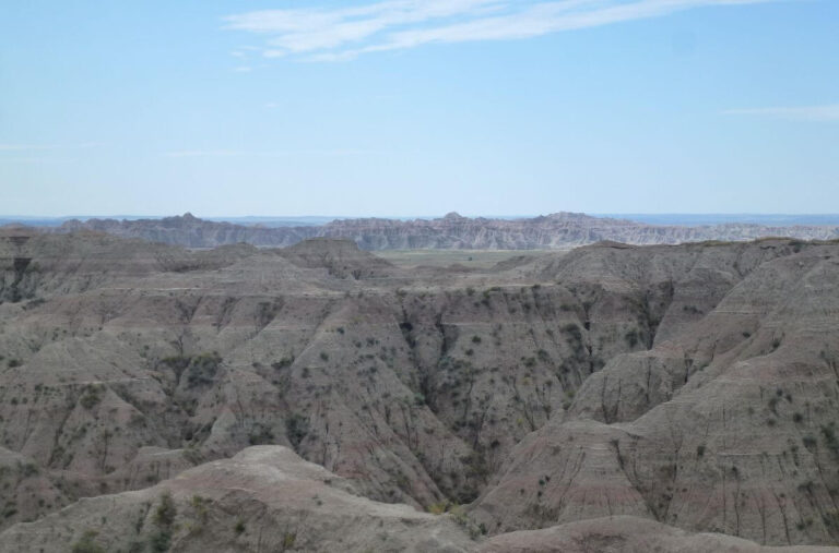 rock hills that are pink and white, you can see the lines through them from the different time periods and that it has taken millions of years to carve the valleys running between and down them