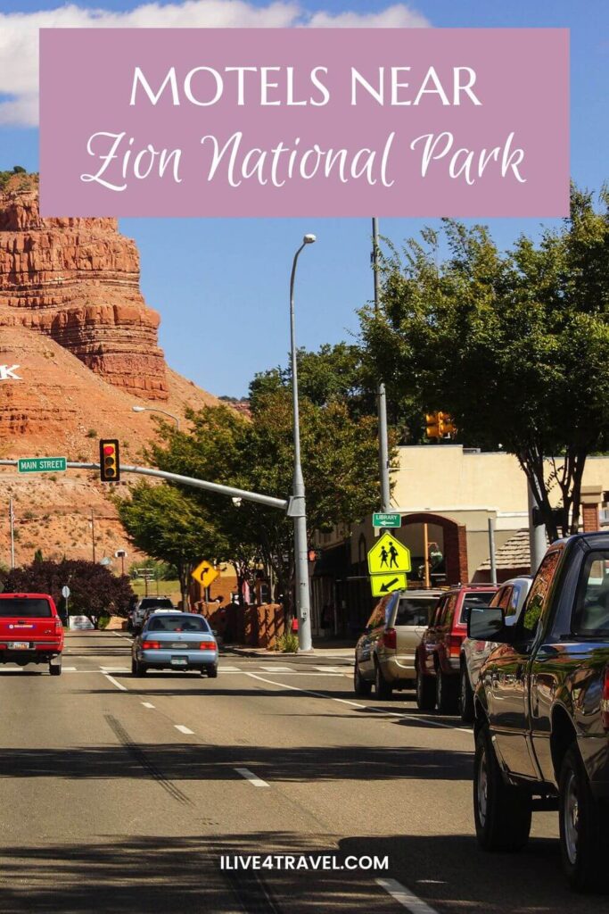 a pinterest pin about motels near Zion National Park, showing a street with cars driving down it in a town with orange cliffs at the end 