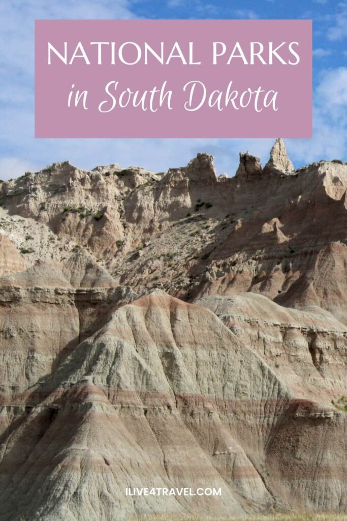 Pinterest pin featuring layered rock formations in Badlands National Park, South Dakota, with a pink text overlay reading ‘National Parks in South Dakota’ against a blue sky.