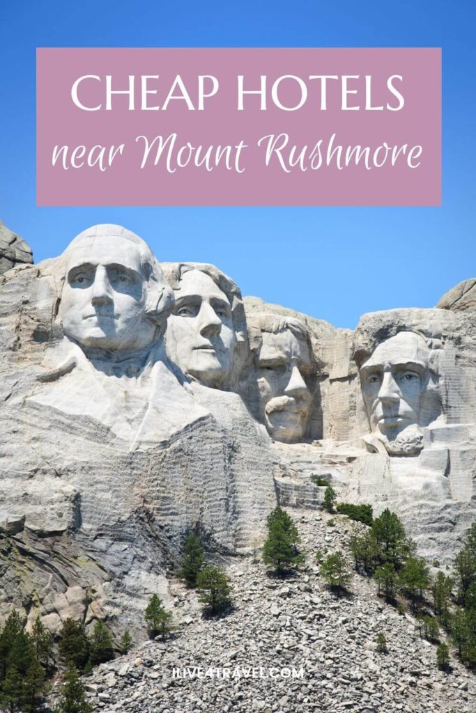 Pinterest pin showing Mount Rushmore National Memorial with the carved faces of four U.S. presidents under a clear blue sky. Text across the top reads “Cheap Hotels near Mount Rushmore”